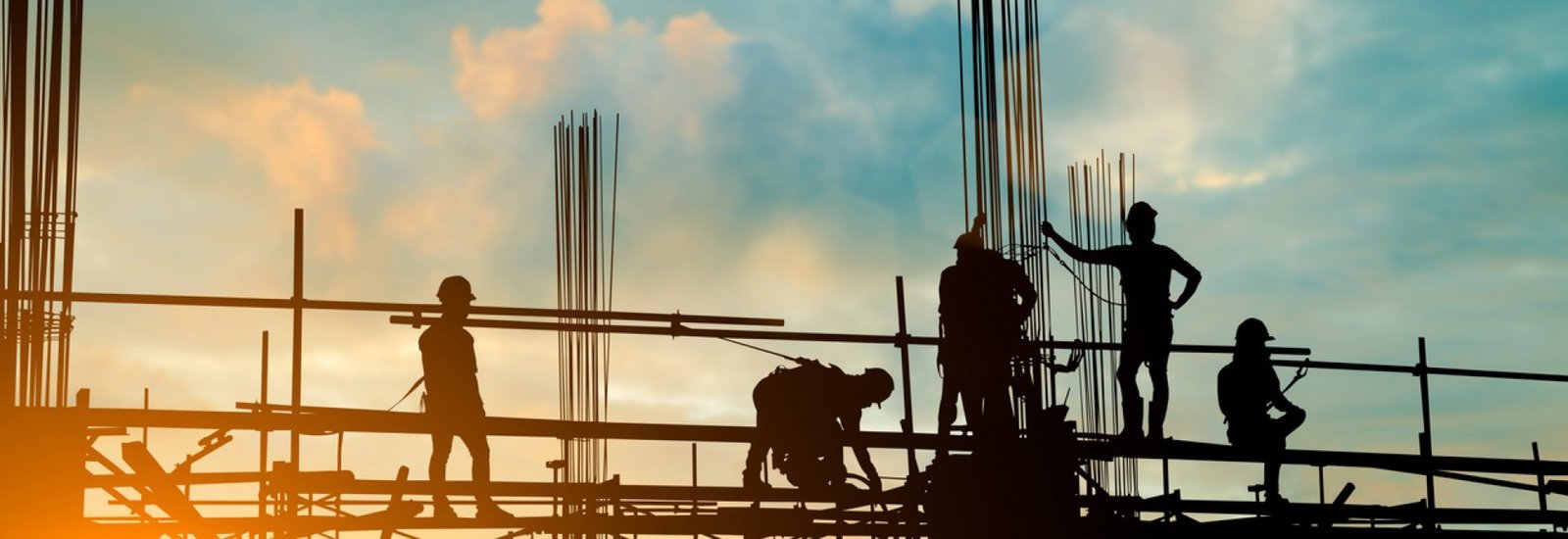 Silhouette of engineer and construction team working safely on scaffolding on high rise building. over blurred background sunset pastel for industry background with Light fair